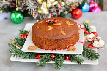 Indian Christmas celebration serving homemade Christmas plum cake India Kerala. Fruitcake made of...