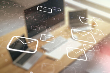 Double exposure of postal envelopes hologram and modern desktop with laptop on background....