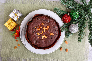 Indian Christmas celebration serving homemade Christmas plum cake India Kerala. Fruitcake made of dried fruit, nuts, spices , rum for New Year party, Easter, Christmas Eve