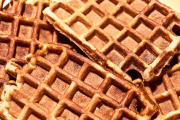 Close up shot of freshly baked Belgian waffles, traditional Belgian dessert