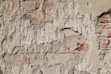 Demolished stone wall with exposed bricks, red, cracked and damaged brick wall, background for template, no person
