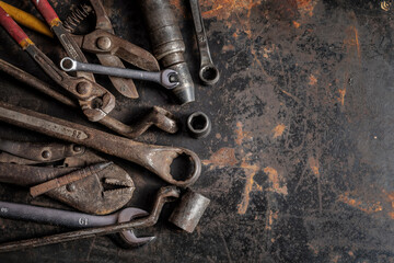 Flat lay Old hand tools ,Pliers screwdriver wrench rusted iron metal tools on Steel plate at garage