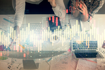 Double exposure of man and woman working together and financial chart hologram drawing. market...