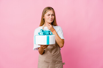 Young russian baker woman holding a delicious cake suffers pain in throat due a virus or infection.