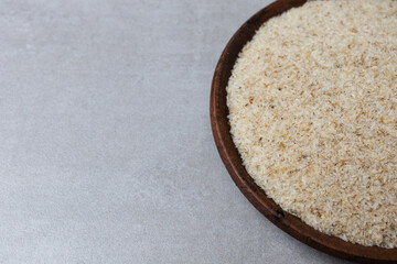 Psyllium in a clay cup on a concrete background. Food bacground. Horizontal orientation. High quality photo