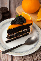 Orange chocolate cake with orange fruit commuter and spoon on a plate.