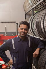 Obraz na płótnie Canvas Portrait of happy technician at a tyre shop 