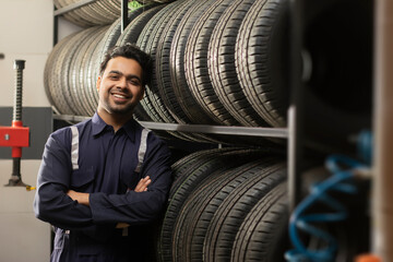 Fototapeta na wymiar Portrait of happy technician at a tyre shop 