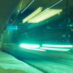 Defocused photography. Traffic. Blurred motion of cable car. Soft green colors. Long exposure image.