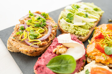 selection board of open sandwiches dips, spreads, cold cut meat, cheese, egg and salad 