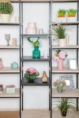 Flowers and decorative decorations on a metal rack in the style of minimalism