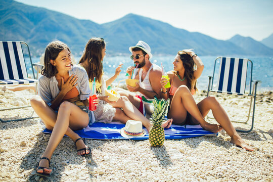 Young Friends Having Fun At The Beach On A Sunny Day. Party Time.