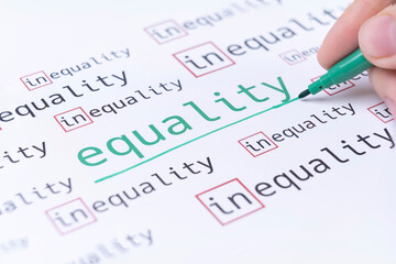Fototapeta premium Hand underlines the word EQUALITY, gender equality concept. Selective focus