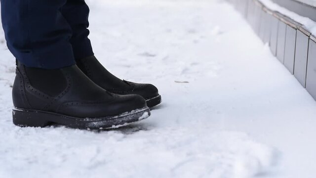 Close-up, shoes and snow on the street in winter, loss and loss of a wallet, distraction and not being attentive. Lose money and wallet with credit cards and documents.
