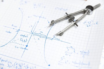 Math exersize in white notebook closeup