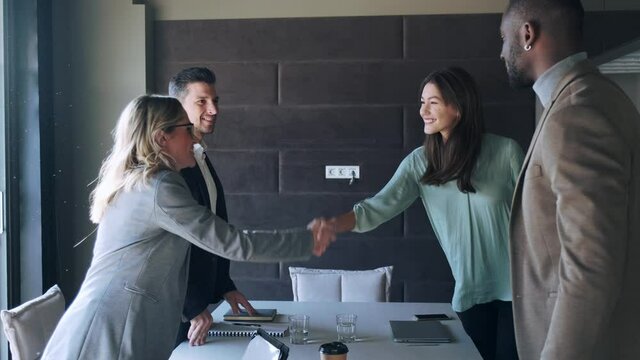 Business partners shaking hands after successful meeting