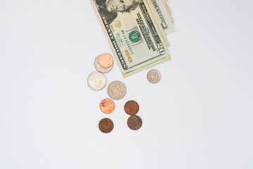 Dollar bills and coins on the white background