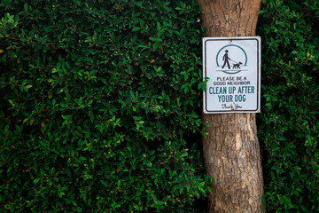 Pet dog poop cleaning sign in residential park community area warning neighbors