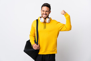 Young sport man with sport bag isolated on white background doing strong gesture