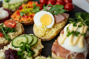 col cut meat egg mayonnaise salad proscuito ham cucumbr cheese open sandwich board selection 