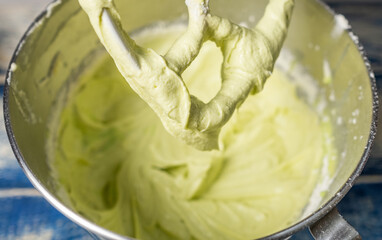 Pandan swiss meringue buttercream in a mixer. Selective focus.