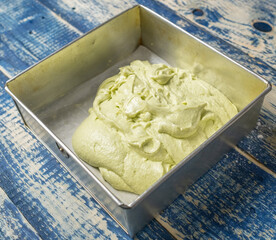 Pandan cake batter in a steel container. Selective focus.