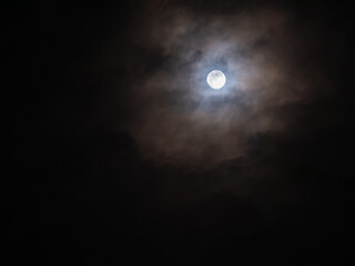 Fototapeta na wymiar Clouds were All Over The Sky behind The Halo Moon