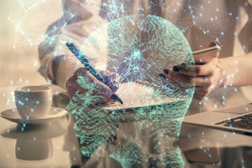 Double exposure of brain sketch hologram and woman holding and using a mobile device.