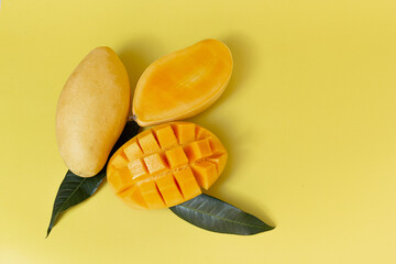 Ripe mango isolated on yellow background, summer concept