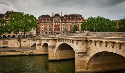 Obraz premium view of the Pont Neuf, bridge which crosses the River Seine from right bank of the Seine River in Paris, France