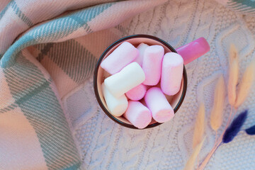 Cup of drink with pink marshmellows on top