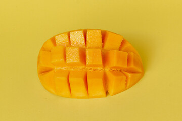 Ripe mango isolated on yellow background, summer concept