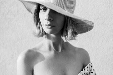 Close up portrait of elegant stylish blonde short hair girl in hat  posing over white background