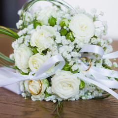 love forever, wedding rings on pillow with beautiful and fragrant flowers