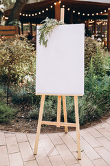 Wedding. There is a white decorated board for the guest list on the street. - obrazy, fototapety, plakaty