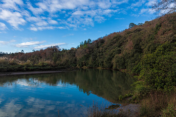 tranquil river in vizcaya in spainwith some clouds in the sky