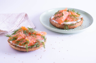 two halves of buns with smoked trout, decorated with fresh dill