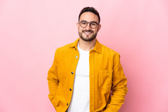 Young caucasian handsome man isolated on pink background laughing