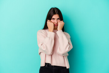 Young caucasian woman isolated on blue background whining and crying disconsolately.