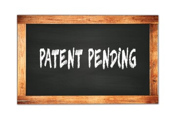 PATENT  PENDING text written on wooden frame school blackboard.