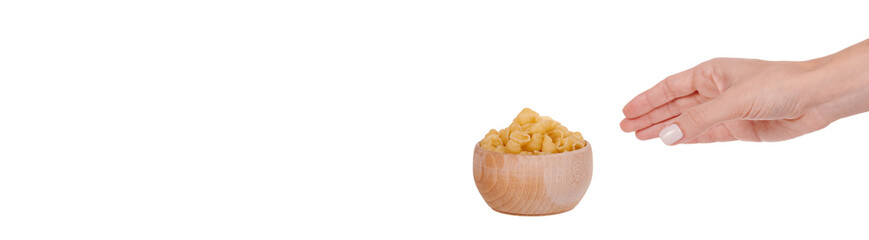 Hand with Fresh raw pasta in wooden bowl. Isolated on white background.