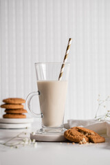 Glass of milk with homemade cookies on a white background. Breakfast and healthy food concept. white on white