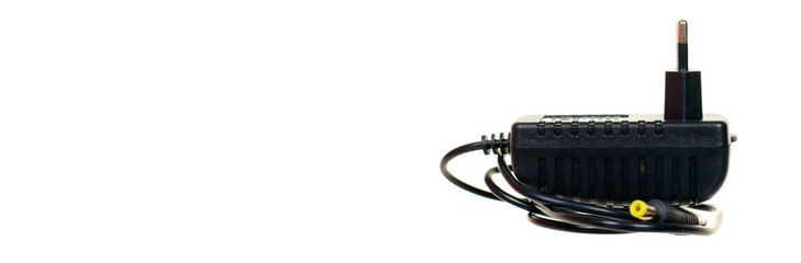Black power adapter isolated on white background.