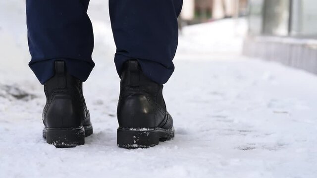 Close-up, shoes and snow on the street in winter, loss and loss of a wallet, distraction and not being attentive. Lose money and wallet with credit cards and documents.