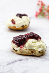 Fruit scone with strawberry jam and cream
