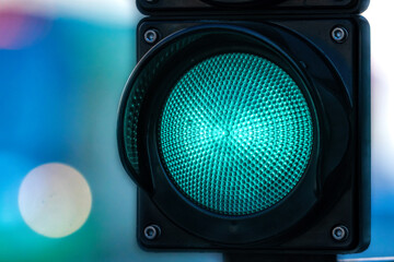close-up of traffic semaphore with green light on defocused city street background with copy space