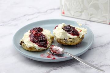 Fruit scone with strawberry jam and cream