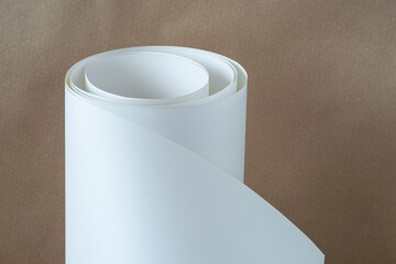 Roll of white paper on a brown background.