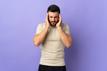 Young handsome man with beard over isolated background with headache