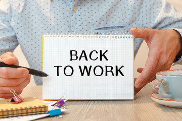 Notebook with text - BACK TO WORK - near office supplies.